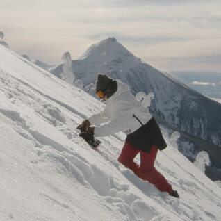 person on snowy slope wearing advanturer gear